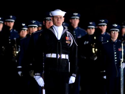 US Navy 061230-F-8968M-058 A Sailor assigned to the Ceremonial Honor Guard, along with members of the United States Air Force band stands at the ready as the casket of Gerald R. Ford, arrives in Washington, DC