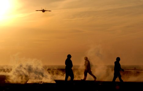 US Navy 070113-N-5345W-046 An F-A-18E Super Hornet assigned to the Gunslingers of Strike Fighter Squadron One Zero Five (VFA-105), flies off into the sunset after launching from the bow of the Nimitz-class aircraf