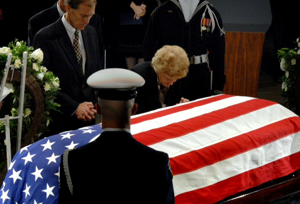 US Navy 061230-D-1142M-018 Former First Lady Betty Ford bows her head over her husband's casket during memorial services at the U.S. Capitol Rotunda, for former President Gerald R. Ford