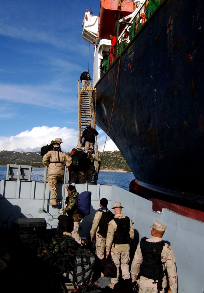 US Navy 070104-N-0780F-003 Members assigned to Alpha Team, Embarked Security Detachment Two Two Three (ESD-223), climb an accommodation ladder to begin an embark aboard Condock V, a Heavy Lift Vessel contracted by Military Seal