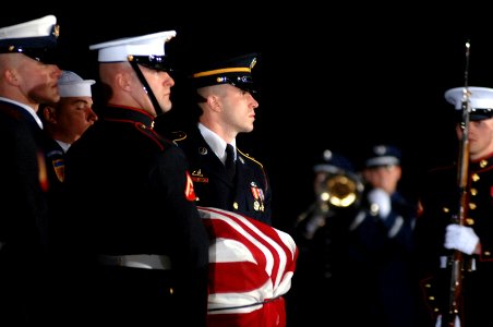 US Navy 061230-F-8968M-100 The casket of former President of the United States Gerald R. Ford is carried by a Ceremonial Honor Guard at Andrews Air Force Base, Md., Dec. 30, 2006