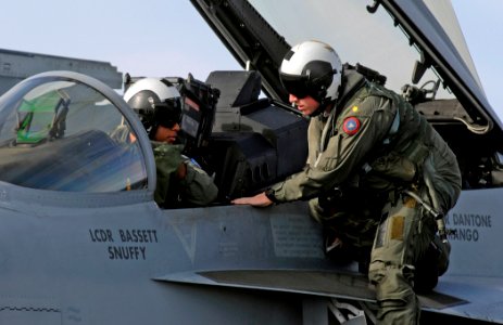 US Navy 070115-N-5345W-084 Naval aviators assigned to the Swordsmen of Strike Fighter Squadron Three Two (VFA-32) discuss their most recent flight while climbing out of the cockpit