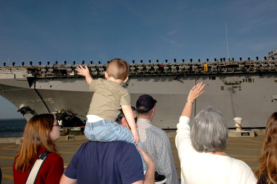 US Navy 070104-N-4515N-035 Family and friends of Sailors aboard the amphibious assault ship USS Bataan (LHD 5) gather at Naval Station Norfolk to say goodbye as they start their deployment