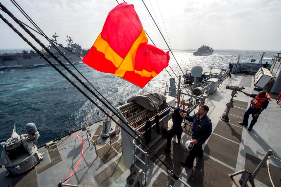 USS Fort McHenry hoists a Romeo flag during an underway replenishment. (16347739156)