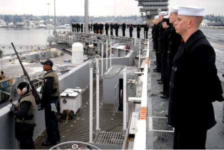 US Navy 070116-N-0684R-147 Security personnel man a .50-caliber machine gun while Sailors man the rails as the USS John C. Stennis (CVN 74) departs Naval Base Kitsap Bremerton for a scheduled deployment