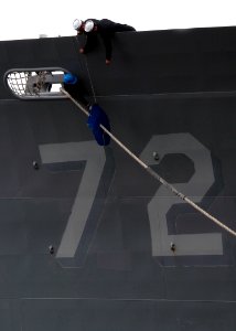 US Navy 070105-N-1713L-042 Sailors remove rat guards as the guided missile cruiser USS Vella Gulf (CG 72) prepares to get underway from Naval Station Norfolk photo