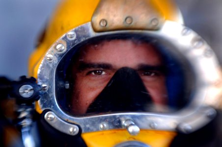 US Navy 070105-N-9769P-162 After conducting final checks on the MK-21 diving helmet, Navy Diver 2nd Class Tim Taylor awaits final instructions before entering the water