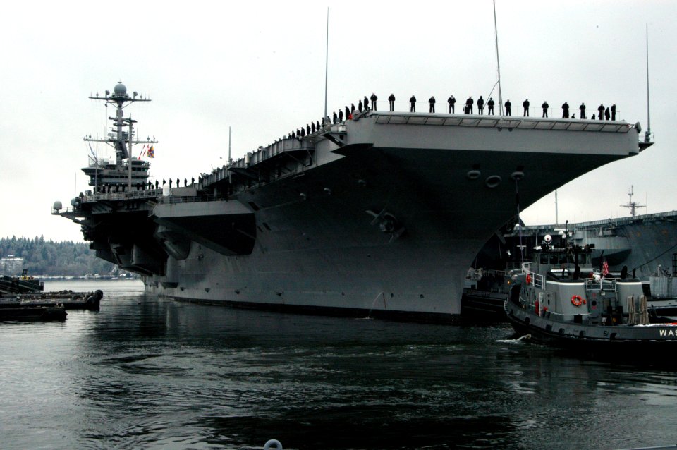 US Navy 070116-N-7656R-003 Sailors man the rails as the Nimitz-class aircraft carrier pulled out of Naval Base Kitsap, Bremerton for their scheduled deployment