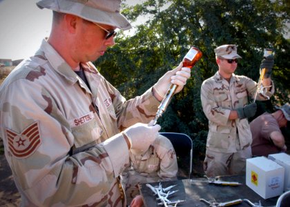 US Navy 070109-N-1328C-218 Tech. Sgt. Chris Shetterly, from Olympia, Wash., and other veterinarians and medical personnel prepare medications for a Veterinarian Civil Action Program (VETCAP)