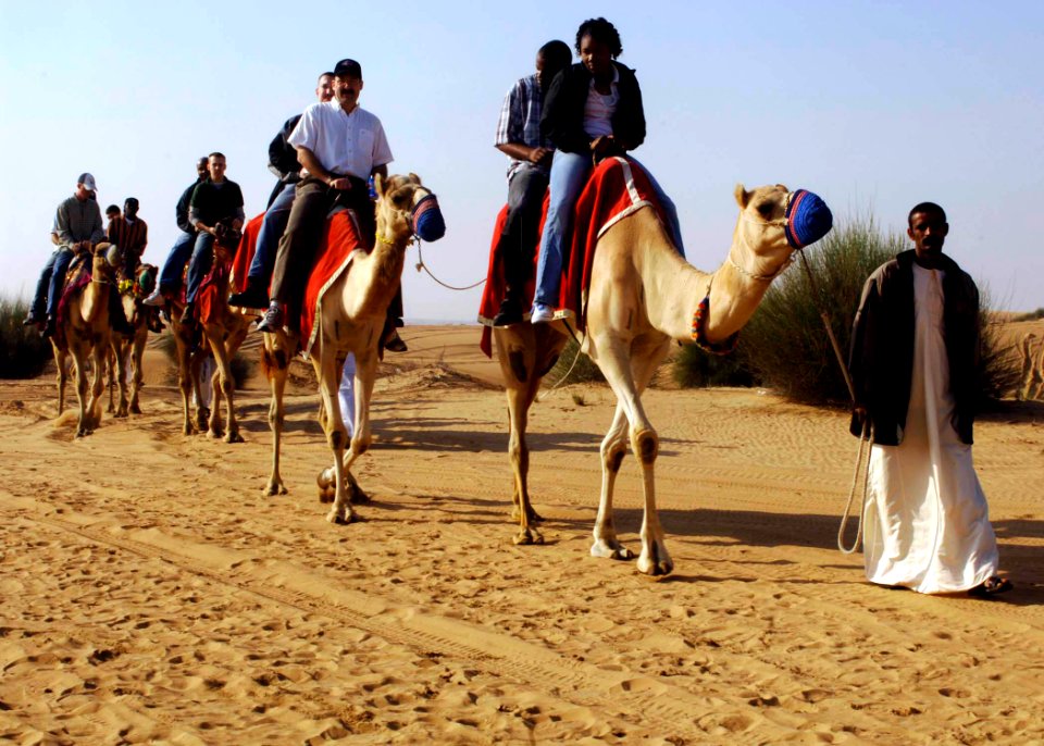 US Navy 061224-N-5330L-069 Sailors from the Nimitz-class aircraft carrier USS Dwight D. Eisenhower (CVN 69) take the opportunity to ride a camel during a Morale Welfare and Recreation sponsored tour