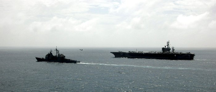 US Navy 070112-N-0490C-003 The Ticonderoga-class guided missile cruiser USS Bunker Hill (CG 52) comes alongside of the Nimitz-class aircraft carrier USS Dwight D. Eisenhower (CVN 69) to observe flight operations