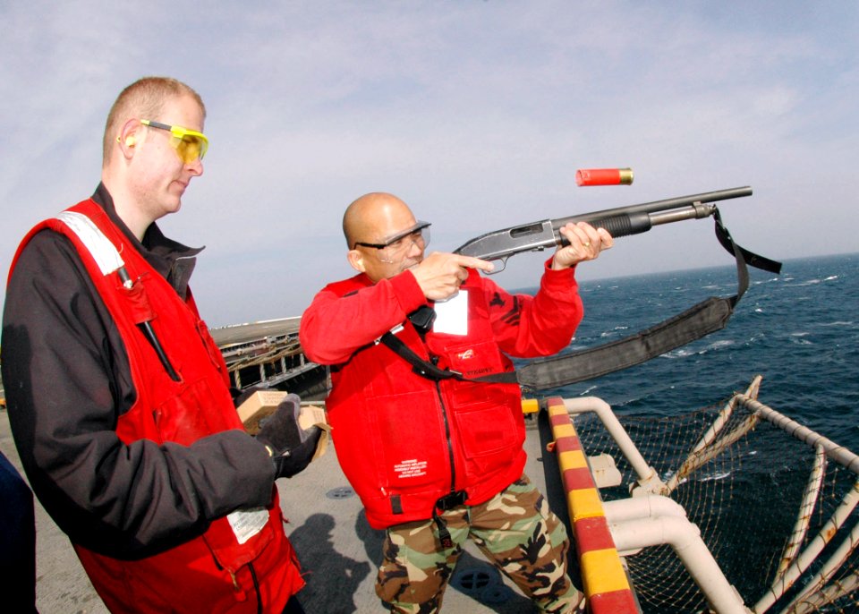 US Navy 070115-N-0209M-006 A Sailor fires a shotgun during live-fire training aboard the amphibious assault ship USS Boxer (LHD 4)