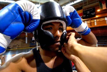 US Navy 070119-N-4965F-004 U.S. Coast Guard Food Service Specialist 3rd Class Lamont Brown assigned to the Honolulu based Coast Guard Cutter Jarvis (WHEC 725), has his headgear adjusted