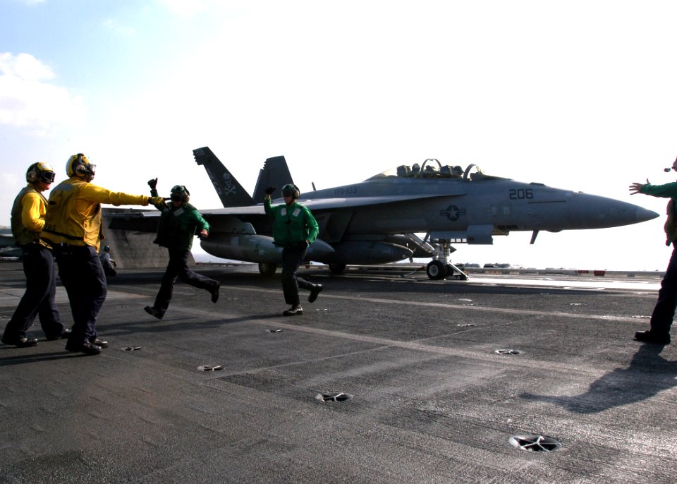 US Navy 061230-N-8907D-002 An F-A-18F Super Hornet assigned to the Jolly Rogers of Strike Fighter Squadron One Zero Three (VFA-103) prepares to launch from the flight deck of the Nimitz-class aircraft carrier USS
