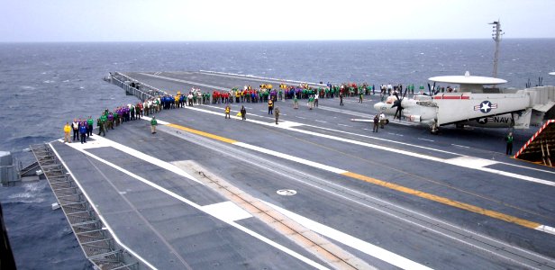 US Navy 070116-N-0535P-011 Sailors walk the flight deck of the Nimitz-Class aircraft carrier USS Harry S. Truman (CVN 75) in search of foreign object debris (FOD) before flight operations