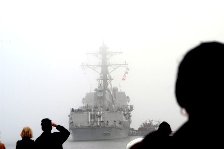 US Navy 070105-N-1713L-029 Families watch as guided missile destroyer USS Nitze (DDG 94) departs into the fog at Naval Station Norfolk photo