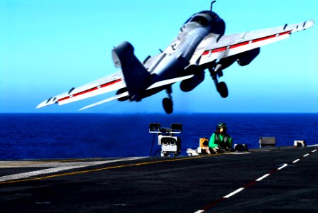 US Navy 070123-N-3729H-136 An EA-6B Prowler assigned to the Yellowjackets of Tactical Electronic Warfare Squadron One Three Eight (VAQ-138) takes off from the flight deck as Aviation Boatswains Mate 2nd Class Montego Kornegay p