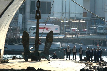 US Navy 070116-N-5387K-024 Deck department Sailors stand clear of the starboard anchor of USS Kitty Hawk (CV 63) as it is lowered onto a barge