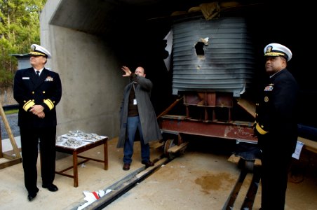 US Navy 070116-N-7676W-021 Andrew Wyman, center, range test engineer at the Naval Surface Warfare Center, Dahlgren Division (NSWCDD), explains the impact from the Electromagnetic Railgun (EMRG) to Rear Adm. William E. Landay, C