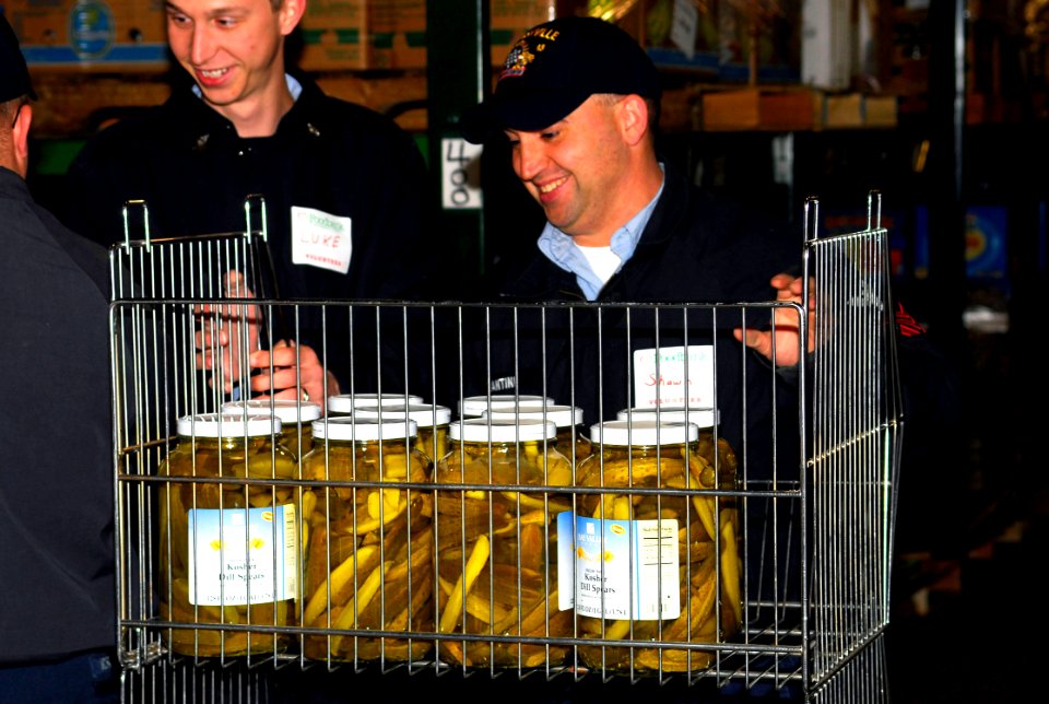US Navy 070117-N-1831S-031 Sailors assigned to amphibious transport dock USS Nashville (LPD 13) sort through food items at the South Eastern Hampton Roads Food Bank