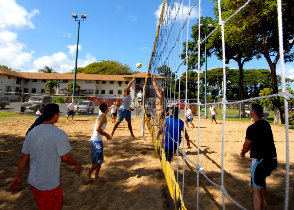 US Navy 070118-N-4965F-004 A Sailor jumps and stretches to return a volley during a volleyball tournament on board Naval Station Pearl Harbor during the annual Surface Navy Association, Surface Line Week