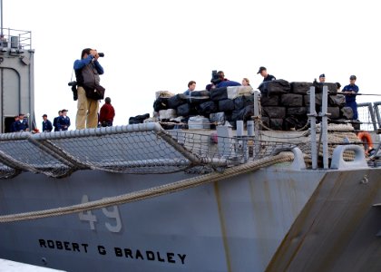 US Navy 070112-N-8544C-003 Sailors aboard the guided missile frigate USS Robert G. Bradley (FFG 49) prepare to offload 23 tons of illegal drugs seized in a multi-national and interagency effort to interdict the flow of narcotic