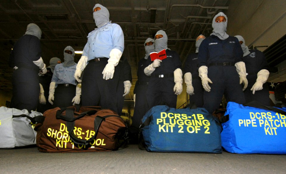 US Navy 070117-N-8923M-028 Sailors assigned to repair locker one bravo gather damage control gear in the hangar bay during a general quarters drill on board the Nimitz-class aircraft carrier USS Harry S. Truman (CVN 75)