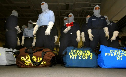US Navy 070117-N-8923M-028 Sailors assigned to repair locker one bravo gather damage control gear in the hangar bay during a general quarters drill on board the Nimitz-class aircraft carrier USS Harry S. Truman (CVN 75)