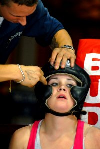 US Navy 070119-N-4965F-014 Fire Controlman 3rd Class Kris Merritt, assigned to Arleigh Burke-class guided-missile destroyer USS Chafee (DDG 90), has her hair put underneath her headgear