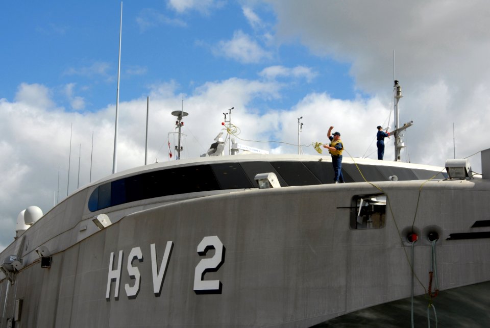 US Navy 070125-N-4965F-010 A Sailor assigned to U.S. Navy High-Speed Vessel (HSV-2) Swift throws a mooring line to a line handler on the pier as she moors at Naval Station Pearl Harbor