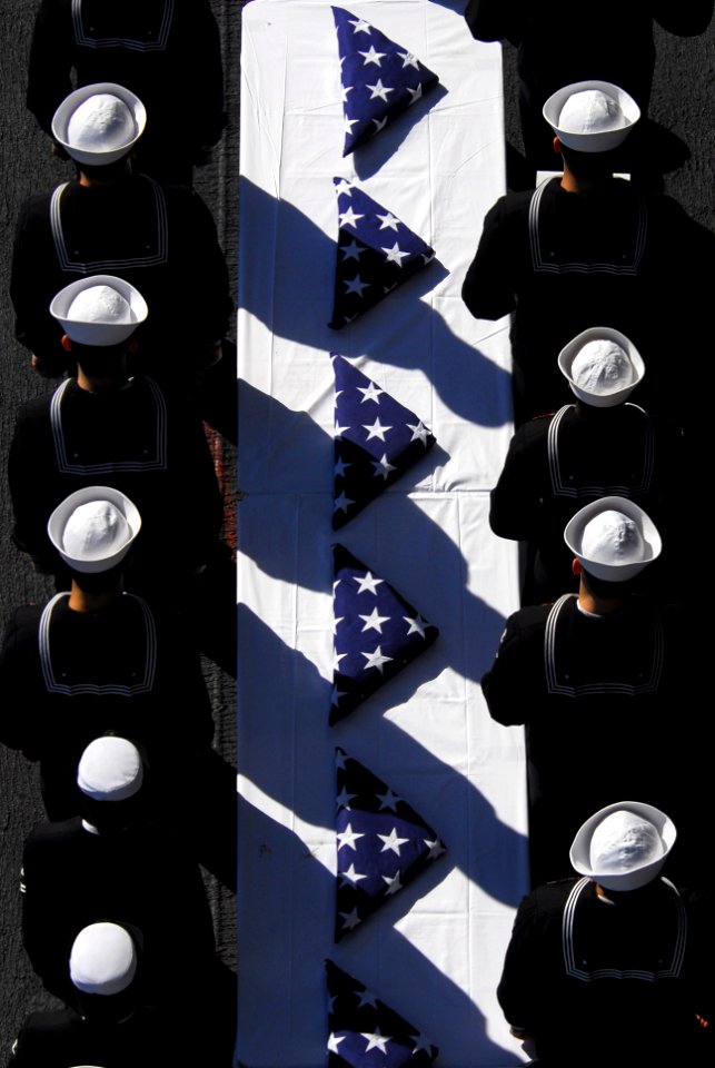 US Navy 070115-N-8158F-017 On board nuclear powered-aircraft carrier USS Nimitz (CVN 68), flag bearers stand in formation during a burial at sea ceremony
