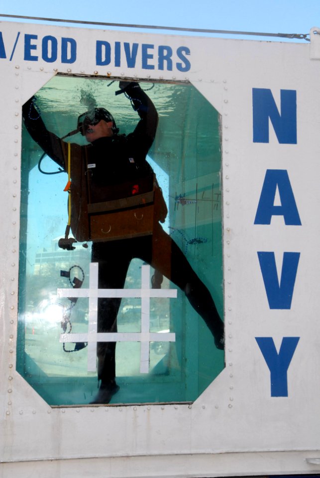 US Navy 070127-N-0318S-001 Master Diver Kyle Gaillard assigned to the Naval Special Warfare Center Panama gathers parade beads in the Explosive Ordnance Disposal (EOD) dive tank to give to people who come up to the dive tank an