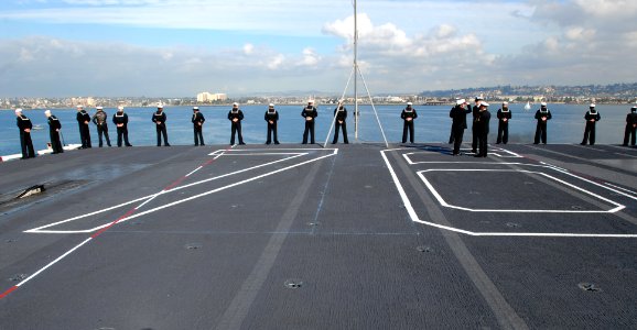 US Navy 070127-N-4133B-082 Sailors man the rails on the flight deck aboard the Nimitz-class aircraft carrier USS Ronald Reagan (CVN 76) while departing on deployment