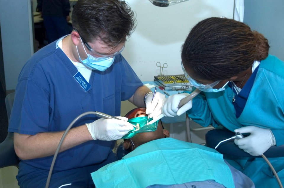 US Navy 070122-N-0483B-002 General dentist Lt. Brian Rounds and Hospital Corpsman Seaman Manouchka Eugene perform a routine cleaning at Fleet Dental on Commander Fleet Activities Yokosuka