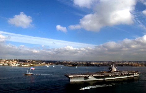 US Navy 070127-N-7130B-270 The Nimitz-class aircraft carrier USS Ronald Reagan (CVN 76) transits San Diego Bay accompanied by several small-craft, including a sailboat displaying a large American flag