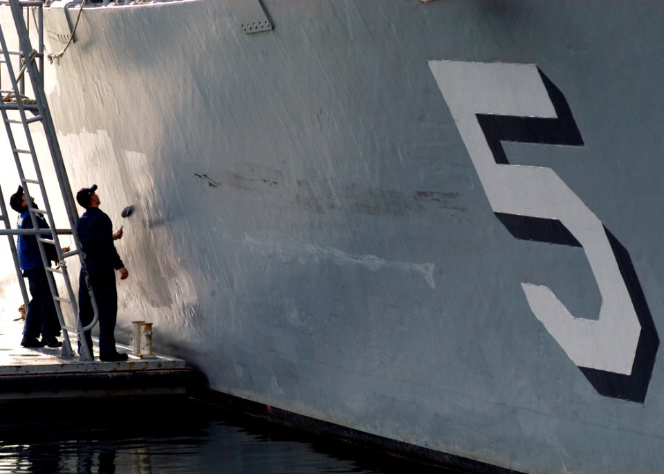 US Navy 070123-N-5253W-024 Sailors aboard the Avenger-class mine hunter USS Guardian (MCM 5) paint the hull while in port at Commander Fleet Activities Yokosuka during the ship's visit from it's home port of Sasebo, Japan