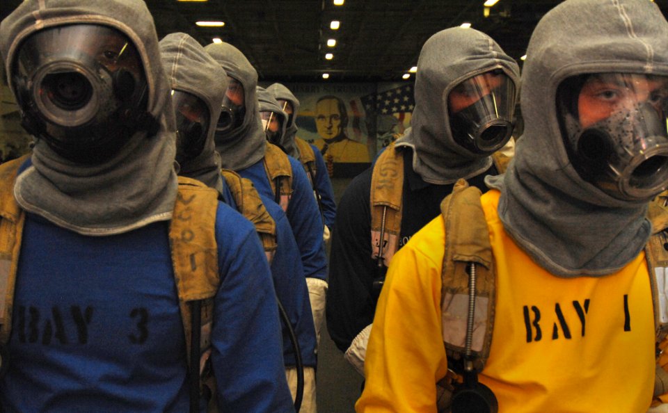 US Navy 070117-N-8923M-038 Fire team members stand by while waiting to respond to several simulated fires in the hangar bay during a general quarters drill on board the Nimitz-class aircraft carrier USS Harry S. Truman (CVN 75)