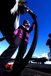 US Navy 070128-N-3729H-049 Aviation Boatswain's Mate (Fuel) Airman Jessica Smith fuels an aircraft prior to launch aboard Nimitz-class aircraft carrier USS John C. Stennis (CVN 74)