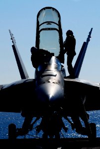 US Navy 070123-N-3729H-075 Pilots conducts a pre-flight inspection on an F-A-18F Super Hornet assigned to the Black Knights of Strike Fighter Squadron One Five Four (VFA-154) on the flight deck aboard the Nimitz-class aircraft