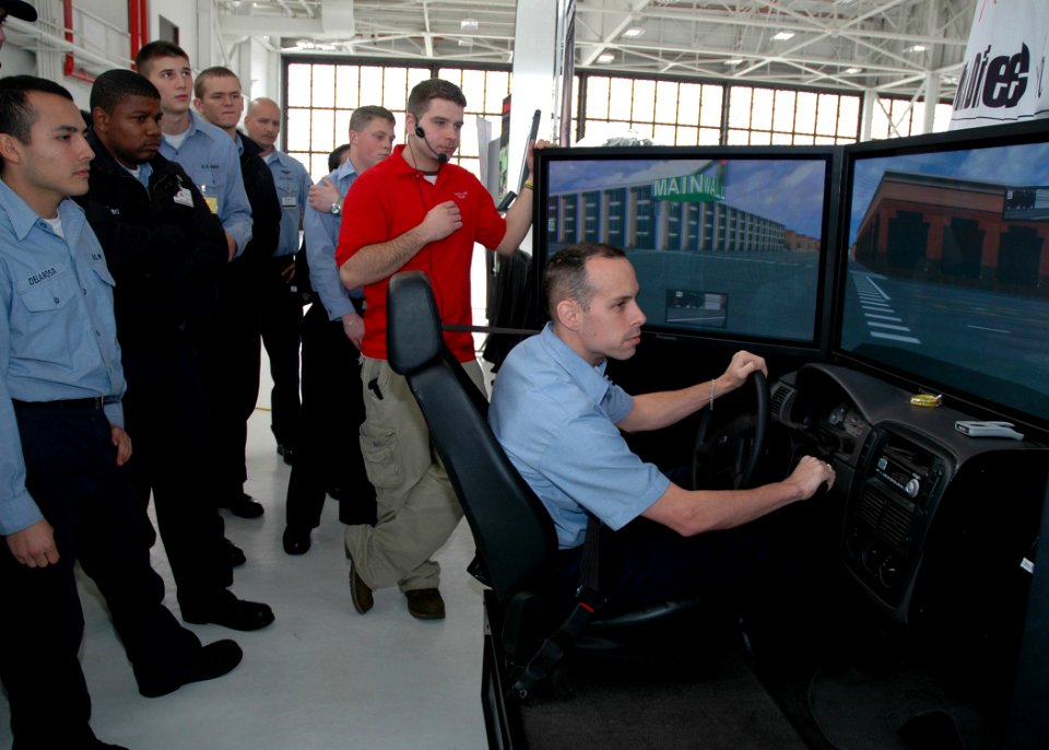 US Navy 070124-N-1522S-048 Sailors look on as Aviation Electrician's Mate 1st Class Jamie Brew participates in a demonstration provided by the