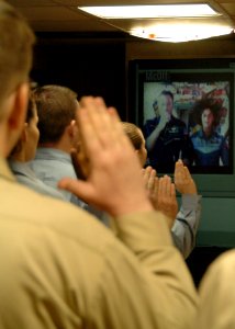 US Navy 070129-N-0490C-002 Orbiting 200 miles above Earth, astronauts, U.S. Navy Capt. Michael Lopez-Alegria, commander for the International Space Station (ISS), and flight engineer U.S. Navy Cmdr. Suni Williams reenlist 16 Sa