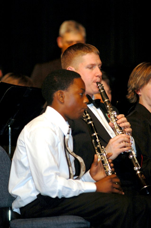 US Navy 070120-N-3957E-079 Chief Musician Michael M. Shelburne plays clarinet alongside a Randallstown High School student musician during a public concert given by the U.S. Navy Band at Randallstown High School