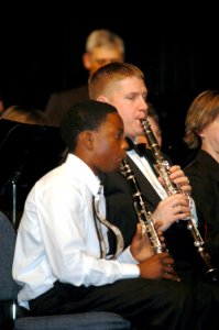 US Navy 070120-N-3957E-079 Chief Musician Michael M. Shelburne plays clarinet alongside a Randallstown High School student musician during a public concert given by the U.S. Navy Band at Randallstown High School