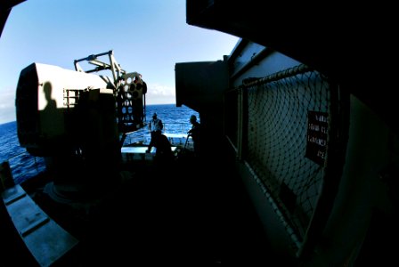 US Navy 070125-N-3729H-045 Fire controlmen assigned to combat systems department lift a case of RAM-116 Rolling Airframe Missiles (RAM) to load into the RAM Battery by crane aboard the Nimitz-class aircraft carrier USS John C