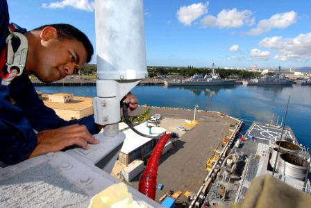 US Navy 070124-N-4965F-011 Electronics Technician 1st Class Donny Fa'avi, Leading Petty Officer for Combat Systems Electronics, Communications and Radar Division , performs pre-deployment maintenance