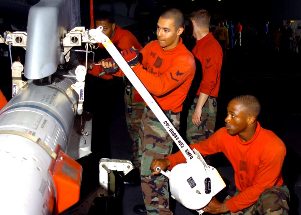 US Navy 070124-N-8907D-002 Sailors attached to the Wildcats of Strike Fighter Squadron One Three One (VFA-131) practice ordnance handling techniques on an F-A-18C Hornet