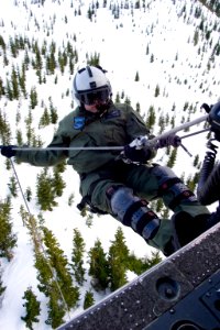 US Navy 070125-N-9150R-058 Helicopter in-flight rescue crewman, Aviation Warfare Systems Operator 2nd Class Marko Vignjevic begins his rappel from an MH-60S Seahawk search and rescue (SAR) helicopter