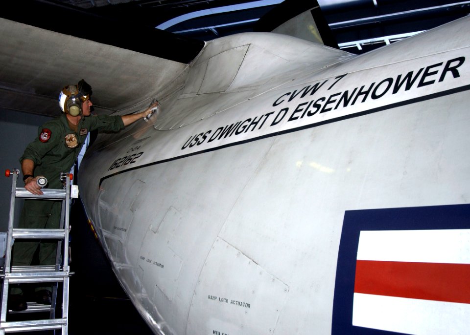US Navy 070129-N-6854D-001 A Sailor cleans an E2-C Hawkeye assigned to the Tigertails of Carrier Airborne Early Warning Squadron One Two Five (VAW-125) in the hangar bay of the Nimitz-class aircraft carrier USS Dwight D. Eisenh