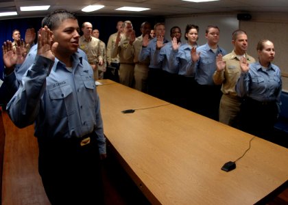 US Navy 070129-N-8907D-001 Sixteen Sailors aboard Nimitz-class aircraft carrier USS Dwight D. Eisenhower (CVN 69) repeat the Oath of Enlistment presided over by astronauts U.S. Navy Capt. Michael Lopez-Alegria and U.S. Navy Cmd photo
