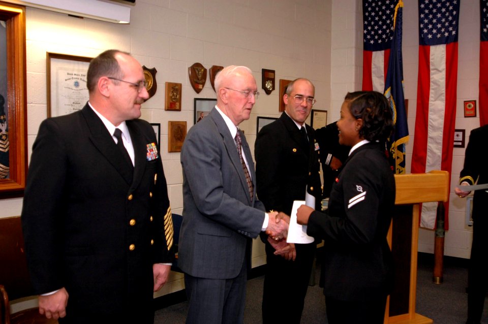 US Navy 070126-N-2456S-073 The Third Master Chief Petty Officer of the Navy (MCPON) Robert J. Walker congratulates Operations Specialist Seaman Apprentice D'Ebony Simons on graduating from